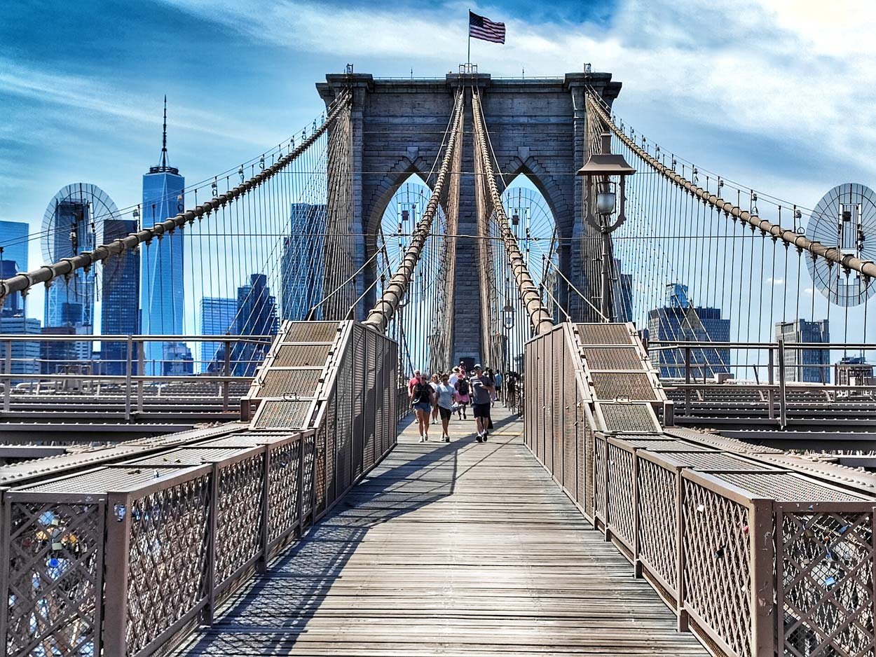 Brooklyn Bridge spanning the East River with Manhattan skyline in background